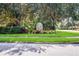 Welcoming entrance sign surrounded by lush landscaping and mature oak trees at 7608 Teal Trce, Bradenton, FL 34203