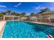 Inviting community swimming pool with plenty of lounge chairs and a covered pergola at 7608 Teal Trce, Bradenton, FL 34203