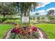 Charming community entrance sign surrounded by vibrant flowers and lush landscaping at 7608 Teal Trce, Bradenton, FL 34203