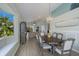 Dining room featuring a large window seat and an open floor plan flowing to the living space at 7608 Teal Trce, Bradenton, FL 34203