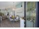 Elegant dining area featuring hardwood floors, a decorative chandelier, and a view into the living room at 7608 Teal Trce, Bradenton, FL 34203