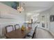 Elegant dining room with hardwood floors, a chandelier, and an open view to the modern kitchen at 7608 Teal Trce, Bradenton, FL 34203