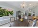 Dining room with bright natural light showcasing an elegant table set and seamless flow to the living area at 7608 Teal Trce, Bradenton, FL 34203