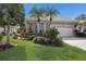 Charming home showcasing manicured lawn and vibrant landscaping, creating a welcoming curb appeal at 7608 Teal Trce, Bradenton, FL 34203