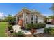 Welcoming home exterior with neatly trimmed hedges and pathway, surrounded by colorful landscaping at 7608 Teal Trce, Bradenton, FL 34203