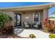 Cozy front porch with seating, complemented by lush tropical plants and decorative lighting at 7608 Teal Trce, Bradenton, FL 34203