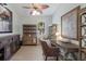 Inviting home office with wood furnishings, light walls, and a lovely leaf ceiling fan at 7608 Teal Trce, Bradenton, FL 34203