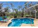 Sparkling pool in screened enclosure with lounge chairs and tropical landscaping at 7608 Teal Trce, Bradenton, FL 34203