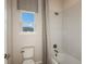 Bright bathroom with a tiled shower, tub, and a window for natural light at 8516 Golden Dawn Ct, Sarasota, FL 34241