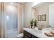 Stylish bathroom with a modern vanity, elegant mirror, and a shower with a patterned curtain at 8516 Golden Dawn Ct, Sarasota, FL 34241