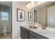 A well-lit bathroom with double sinks, modern fixtures, and decorative accents at 8516 Golden Dawn Ct, Sarasota, FL 34241