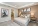 Bedroom showcasing a comfortable bed with decorative pillows, side tables, and en-suite bath at 8516 Golden Dawn Ct, Sarasota, FL 34241