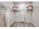 Closet with wire shelving and decorative robes above neutral carpet at 8516 Golden Dawn Ct, Sarasota, FL 34241