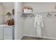 Walk-in closet is well-organized with shelving, hanging rods, and a white bathrobe at 8516 Golden Dawn Ct, Sarasota, FL 34241