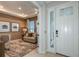 Foyer leads into a living space with a sofa, desk, and modern artwork at 8516 Golden Dawn Ct, Sarasota, FL 34241