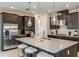 Modern kitchen with stainless steel appliances, a center island, and stylish pendant lighting at 8516 Golden Dawn Ct, Sarasota, FL 34241