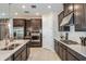 Well-equipped kitchen featuring stainless steel appliances and sleek dark cabinetry at 8516 Golden Dawn Ct, Sarasota, FL 34241