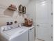 Laundry room is equipped with modern appliances, storage shelves, and stylish decor at 8516 Golden Dawn Ct, Sarasota, FL 34241