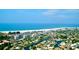 Aerial view of homes, canals, and Siesta Key Beach coastline under a blue sky at 901 Beach Rd # 402, Sarasota, FL 34242