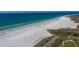 Aerial view of Siesta Key Beach, turquoise gulf waters, and sprawling white sandy beach at 901 Beach Rd # 402, Sarasota, FL 34242