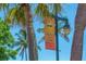 Siesta Key Village welcomes you banner hanging on a light post between palm trees at 901 Beach Rd # 402, Sarasota, FL 34242