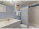 Bright bathroom with sink, toilet, shower/tub combo with blue accents and beach themed decor at 901 Beach Rd # 402, Sarasota, FL 34242