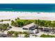 Scenic view of Siesta Key beach with soft white sand, clear blue waters and a building at 901 Beach Rd # 402, Sarasota, FL 34242