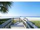 Wooden boardwalk with steps leads to the white sands of Siesta Key Beach, Florida at 901 Beach Rd # 402, Sarasota, FL 34242