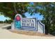 Siesta Beach community sign welcomes residents and visitors with artistic sun and water design at 901 Beach Rd # 402, Sarasota, FL 34242