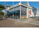 The Beach Club with gray facade, patio, and vibrant mural at 901 Beach Rd # 402, Sarasota, FL 34242