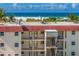 Beachfront condo building with balconies and staircases at 901 Beach Rd # 402, Sarasota, FL 34242