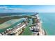 Stunning aerial view of waterfront homes, lush mangroves, and the Gulf of Mexico on a sunny day at 9200 Midnight Pass Rd # 20, Sarasota, FL 34242