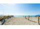 Scenic beach access path with rope railings leading to the beautiful ocean waters at 9200 Midnight Pass Rd # 20, Sarasota, FL 34242