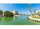 Beautiful waterfront view of a well-maintained channel with condos, docks and lush landscaping at 9200 Midnight Pass Rd # 20, Sarasota, FL 34242