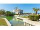 Peaceful waterfront view featuring lush landscaping, docks and a glimpse of the Gulf at 9200 Midnight Pass Rd # 20, Sarasota, FL 34242