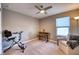 Bedroom setup with an exercise bike, desk, chair, armchair, and carpet flooring at 10811 High Noon Trl, Parrish, FL 34219