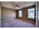 Bedroom featuring plush carpet, ceiling fan, and two windows offering plenty of natural light at 10811 High Noon Trl, Parrish, FL 34219