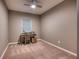 Minimalist bedroom with carpet flooring, ceiling fan, and natural light at 10811 High Noon Trl, Parrish, FL 34219