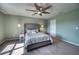 Bedroom featuring a large, comfortable bed, soft carpet, and a ceiling fan at 10811 High Noon Trl, Parrish, FL 34219