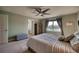 Bright bedroom featuring a nice water view, ceiling fan and a comfortable bed at 10811 High Noon Trl, Parrish, FL 34219