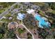 Aerial view of community amenities including pool, splash pad, playground, and green spaces at 10811 High Noon Trl, Parrish, FL 34219