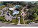 Aerial view of the community pool, splash pad, playground, and surrounding landscape at 10811 High Noon Trl, Parrish, FL 34219