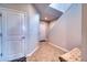 Spacious hallway with neutral paint, tile flooring, and bench seating at 10811 High Noon Trl, Parrish, FL 34219