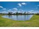 Scenic pond with lush green surroundings, offering a tranquil view and natural beauty at 10811 High Noon Trl, Parrish, FL 34219