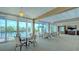 Spacious clubhouse area with tables and chairs, perfect for gatherings with pool views at 1105 Gulf Of Mexico Dr # 603, Longboat Key, FL 34228