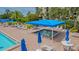 Relax in the pool area with a shaded jacuzzi, tables, chairs, and pool umbrellas at 1105 Gulf Of Mexico Dr # 603, Longboat Key, FL 34228