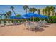 Poolside with tables, chairs and umbrellas for relaxation at 1105 Gulf Of Mexico Dr # 603, Longboat Key, FL 34228