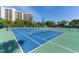 Well-maintained tennis courts with condo building backdrop at 1105 Gulf Of Mexico Dr # 603, Longboat Key, FL 34228