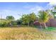 Spacious backyard featuring lush green grass, mature trees, and a fenced perimeter at 1122 42Nd E Ter, Bradenton, FL 34208