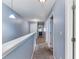 Upstairs hallway with carpet, doors and neutral wall color at 1122 42Nd E Ter, Bradenton, FL 34208